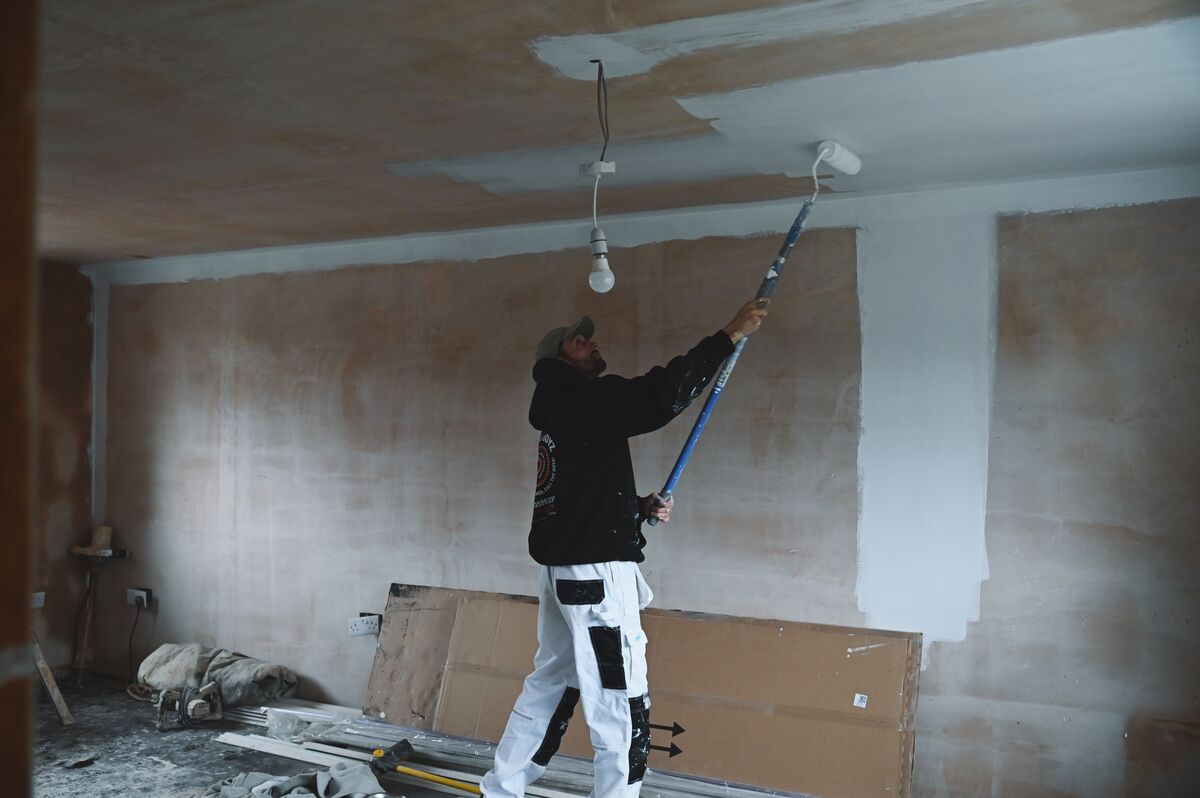 Painting a freshly plastered ceiling during a house renovation in Glenrothes